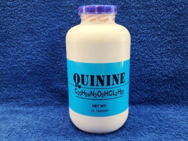 A bottle of quinine is sitting on the floor.