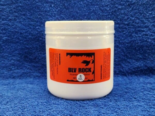 A jar of bull rock on a blue background.