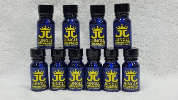 Nine bottles of Jungle Juice Blue arranged in rows on a white textured background.