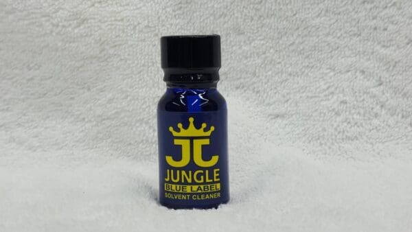 A small bottle of Jungle Juice Blue solvent cleaner on a white fluffy background.