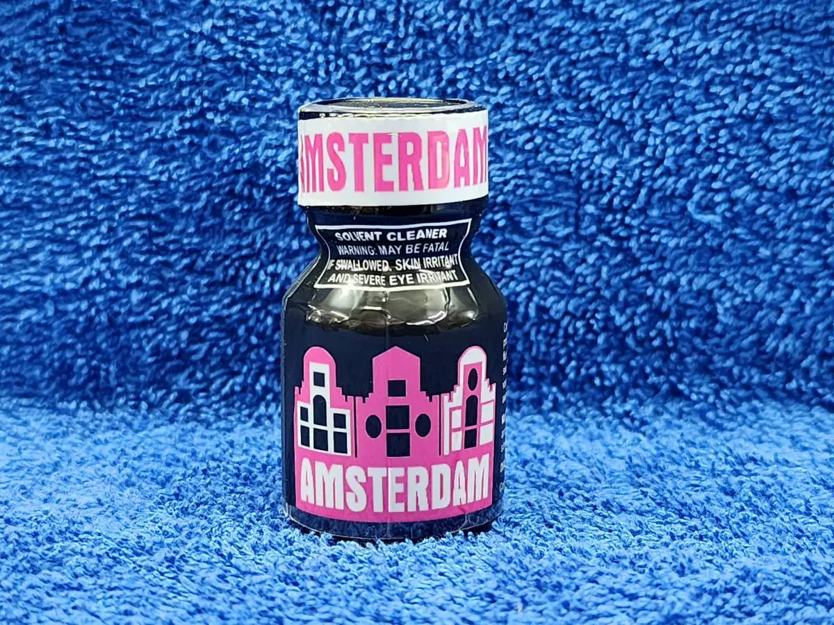 A bottle of amsterdam on a blue towel.