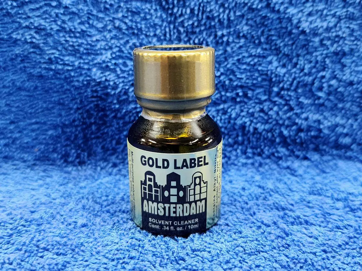 A bottle of gold label on a blue towel.