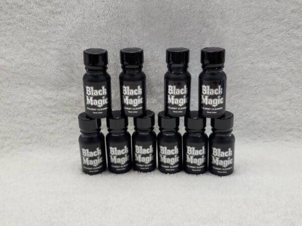 A group of black magic bottles on a white background.