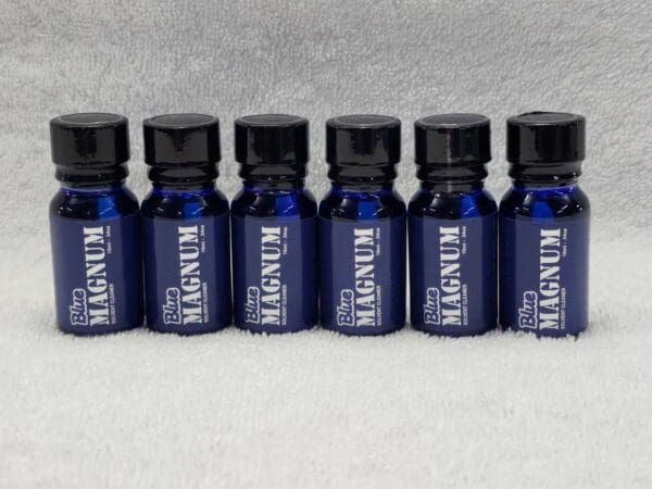 A set of blue bottles with a black label on them.