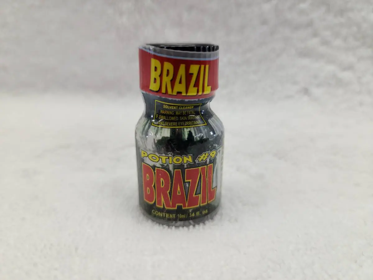 A bottle of brazil coffee on a white surface.