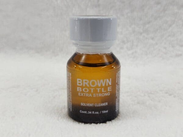 A bottle of brown bottle on a white blanket.