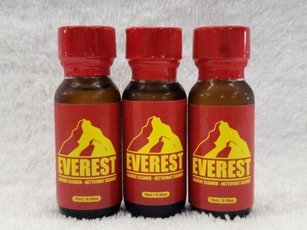 Three bottles of everest oil on a white background.