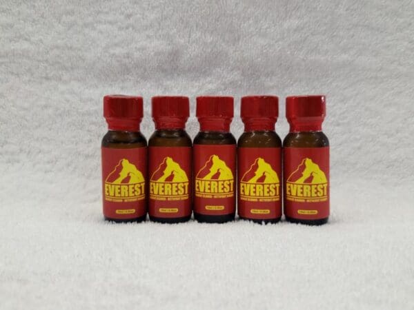 A set of red bottles with a yellow label on them.