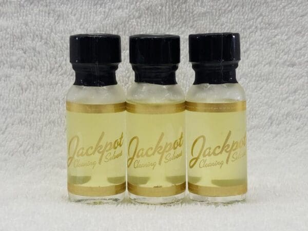 Three bottles of jackson's oil on a white background.