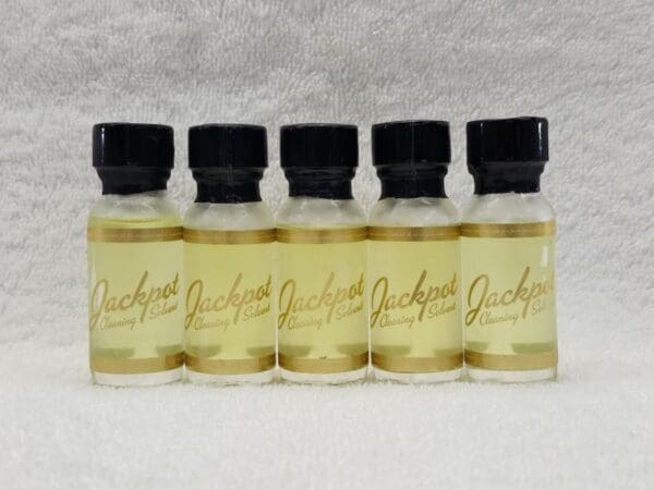 Five bottles of jackson's oil on a white background.