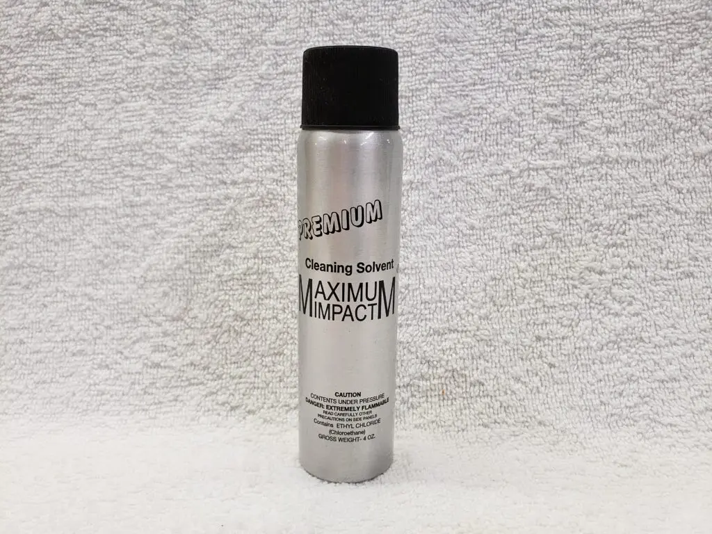 A spray can of hair color on the wall