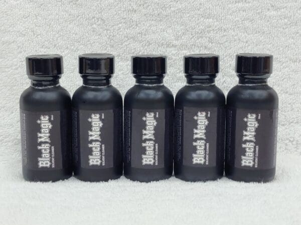 A row of black magic poppers sitting on top of a table.