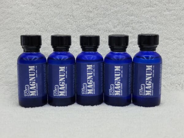 A group of blue bottles sitting on top of a table.