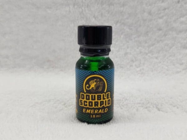 A bottle of e - liquid with a green label on it.