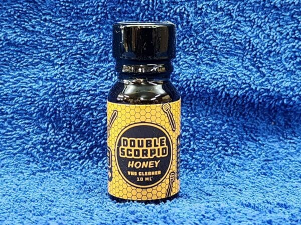 A bottle of honey on a blue towel.