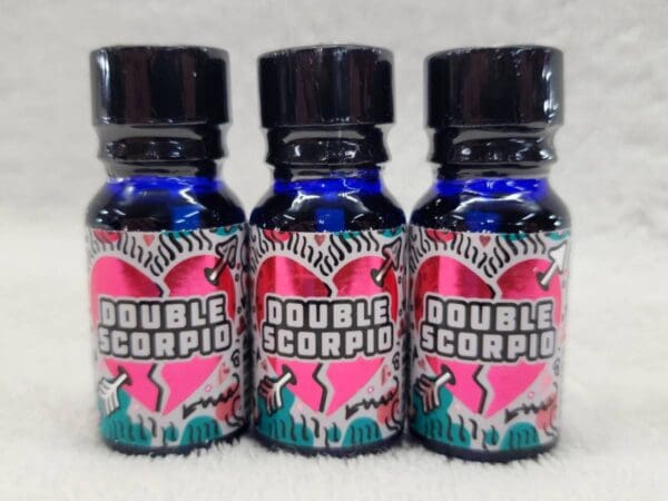 Three bottles of double scorpio on a white surface.