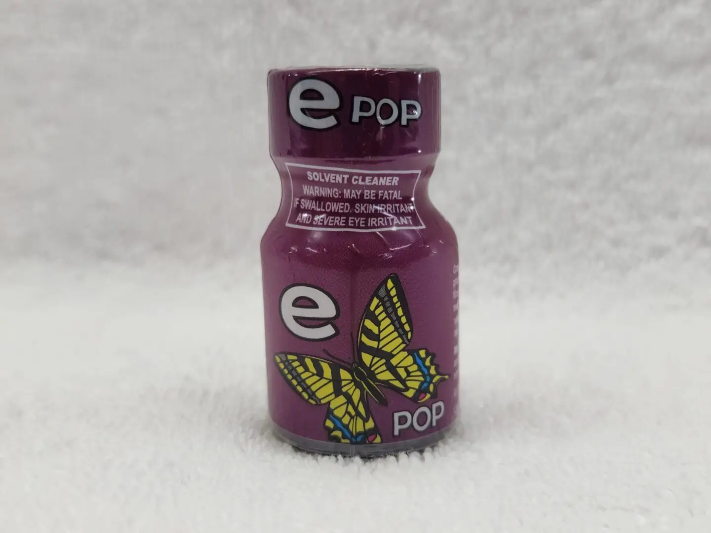 A bottle of Ecstasy Pop with a butterfly on it.