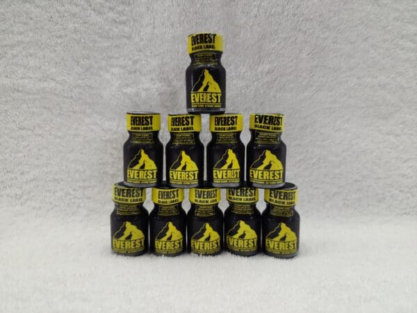 A stack of black and yellow bottles stacked on top of each other.