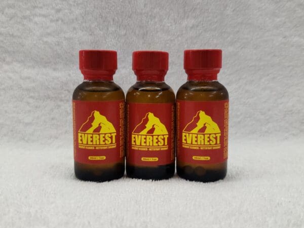 Three bottles of everest poppers on a white background