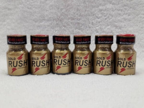 A row of gold rush poppers sitting on top of a table.
