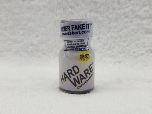 A bottle of Hardware on a white surface.