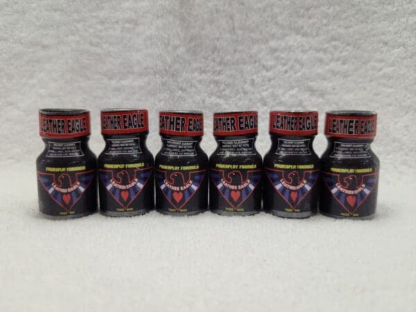 Five bottles of Leather Eagle with a red and black design.