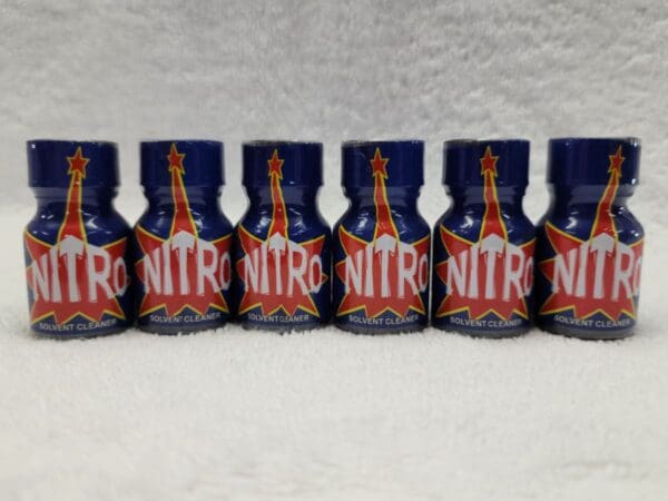 A row of blue and red bottles with nitro on them.