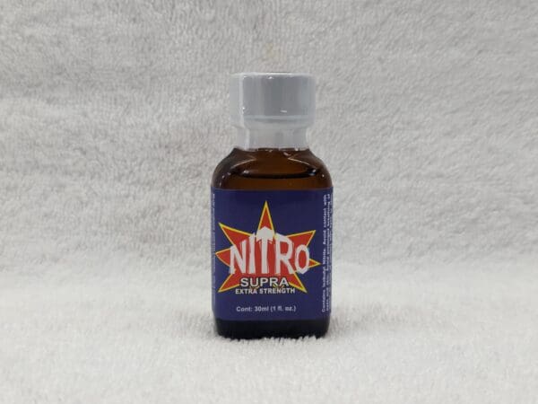 A bottle of nitro fuel sitting on top of a white surface.