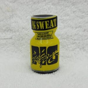 A yellow bottle of poppers on top of a white blanket.