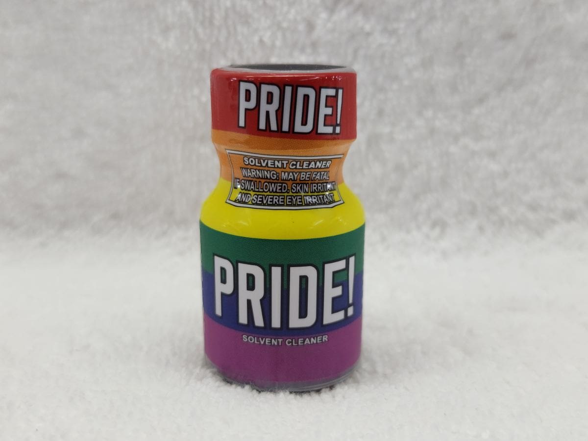 A bottle of pride colored poppers sitting on top of the snow.