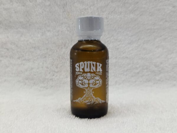 Small brown glass bottle labeled "Spunk" with a graphic design, on a fuzzy white background.