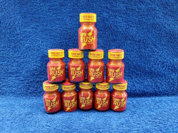 A pyramid of red and yellow bottles on blue background.