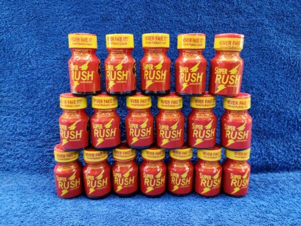 A large group of red and yellow bottles on a blue background.