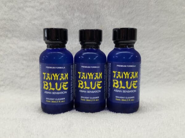 Three bottles of taiwan blue on a white background