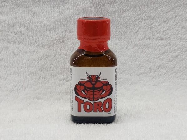 A small bottle labeled "Sapporo" with a red cap and an image of a lobster on a white label, displayed against a white fluffy background.