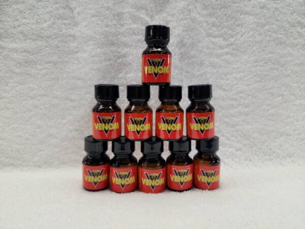 A pyramid of 1 0 bottles of orange flavored potions.